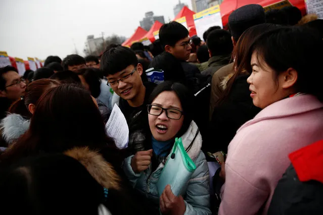 Job seekers crowd an open air job fair for college graduates and the general public in the centre of Shijiazhuang, Hebei province, China, February 6, 2017. (Photo by Thomas Peter/Reuters)