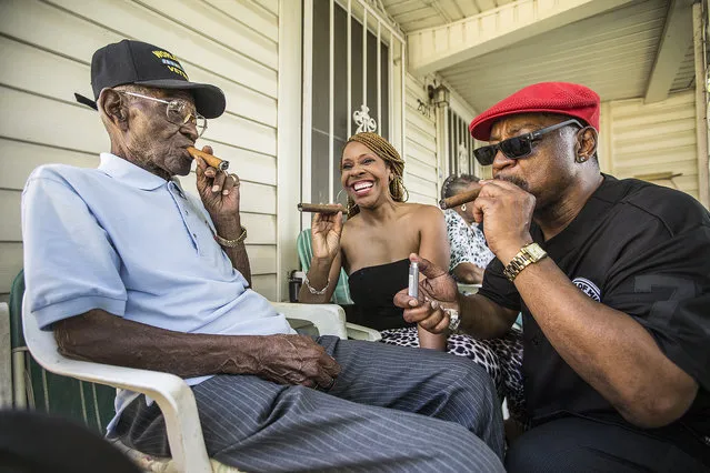 Richard Overton, left,  smokes a cigar with a few neighborhood friends Donna Shorts, center and Martin Wilford Sunday, May 3, 2015, in Austin, Texas. Overton, is considered to be the oldest living World War II veteran in the United States, celebrated his 109th birthday on a front porch in East Austin with friends and family. Wilford, right, says that he has known Overton for 37 years and he looks at Mr. Overton as if he was his biological father.  (Photo by Ricardo B. Brazziell/AP Photo/Austin American-Statesman)