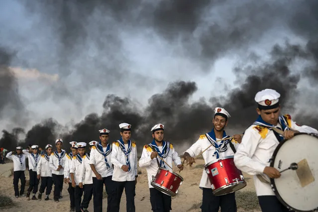 Palestinian boy scouts march during a protest on the beach near the border with Israel in Beit Lahiya, northern Gaza Strip, Monday, September 10, 2018. (Photo by AP Photo)