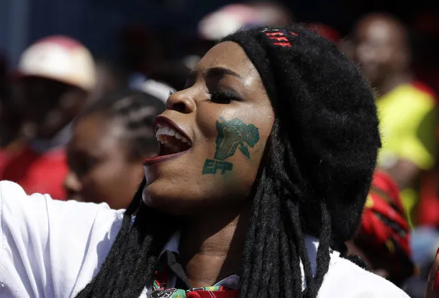 A member of the Economic Freedom Fighters (EFF) party attends a May Day Rally in Alexandra Township, Johannesburg, Wednesday, May 1, 2019. In South Africa, the Economic Freedom Fighters opposition party used the day to rally voters a week before the country's national election. Wearing their signature red shirts and berets, members gathered at a stadium in Johannesburg in cheering support of populist stances that have put pressure on the ruling African National Congress to address issues like economic inequality and land reform. (Photo by Themba Hadebe/AP Photo)