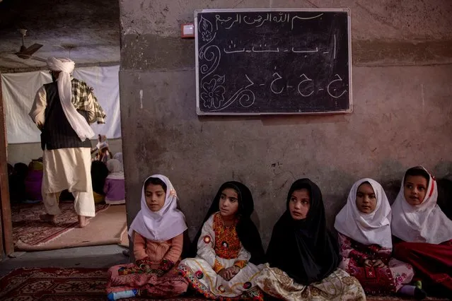 Afghan children attend kindergarten on October 15, 2021 in Nimroz, Afghanistan. Women have not been allowed to work in some cities since the Taliban came to power. The Taliban regained control of Afghanistan and its capital Kabul in mid-August of this year, almost 20 years after they were ousted from power by a US-led coalition in 2001. (Photo by Majid Saeedi/Getty Images)