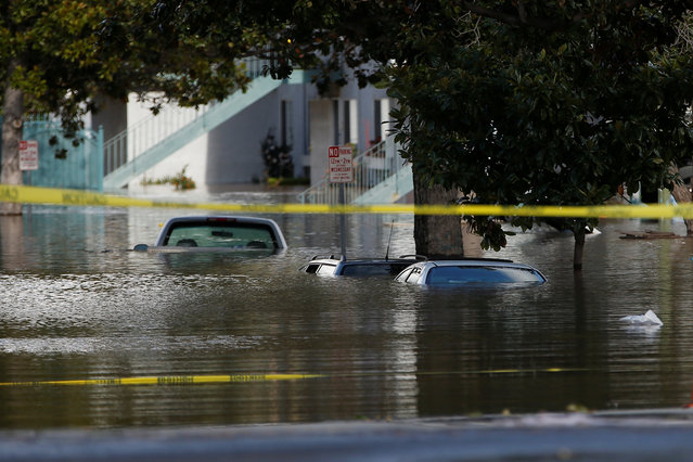 Vehicles are seen partially submerged in flood water after heavy rains overflowed nearby Coyote Creek in San Jose, California, U.S., February 21, 2017. (Photo by Stephen Lam/Reuters)