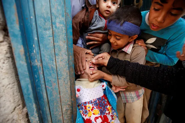 A girl receives polio vaccination drops during a house-to-house vaccination campaign in Yemen's capital Sanaa, April 12, 2016. (Photo by Khaled Abdullah/Reuters)