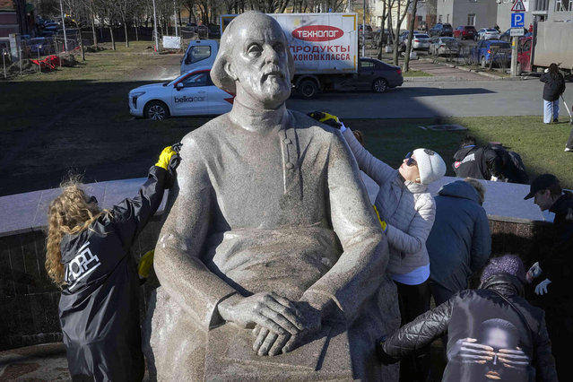 Volunteers wash a sculpture of Konstantin Tsiolkovsky, a Russian and Soviet rocket scientist who pioneered astronautics during Cosmonauts Day celebration in St. Petersburg, Russia, Friday, April 12, 2024. Russia marks the 63rd anniversary of Gagarin's pioneering mission on April 12 1961, the first human flight to orbit that opened the space era. (Photo by Dmitri Lovetsky/AP Photo)