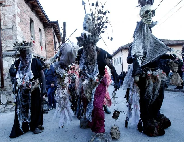 Costumed revelers participate in the carnival parade through the village of Vevcani, in the southwestern part of North Macedonia, on Thursday, January 13, 2022. Hundreds of people participated Thursday and many more watched the carnival celebrations which have been taken place for centuries in the tiny North Macedonia's town of Vevcani. Even though the number of new COVID-19 cases is reaching records in North Macedonia since the beginning of epidemic almost two years ago, authorities did not impose new restrictions. (Photo by Boris Grdanoski/AP Photo)