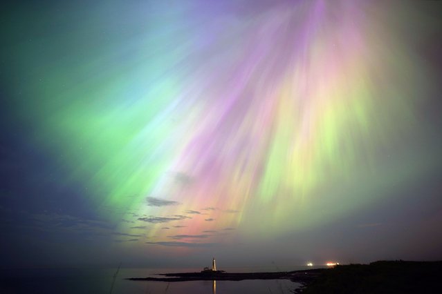 The aurora borealis, also known as the northern lights, glow in the sky over St Mary's Lighthouse in Whitley Bay on the North East coast, UK on Friday, May 10, 2024. (Photo by Owen Humphreys/PA Images via Getty Images)