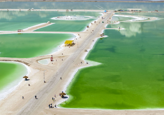 Tourists visit Qarhan Salt Lake in Haixi city, Qinghai province, China, May 31, 2024. With a total area of 5,856 square kilometers, Qarhan Salt Lake is the first salt lake in China and the second largest salt lake in the world. (Photo credit should read CFOTO/Future Publishing via Getty Images)