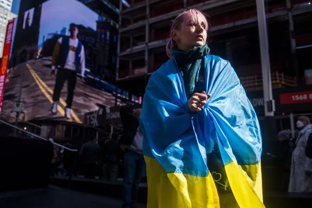 Natalia Baranovskaya listens to people speak and chant at a rally in Times Square to denounce the Russian invasion of Ukraine on Saturday, February 26, 2022, in New York. (Photo by Brittainy Newman/AP Photo)