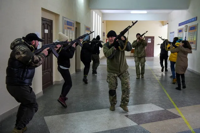 Civilians who volunteered to join the Territorial Defence Forces train on weapons, following Russia's invasion of Ukraine, in Odessa, Ukraine, March 11, 2022. (Photo by Alexandros Avramidis/Reuters)