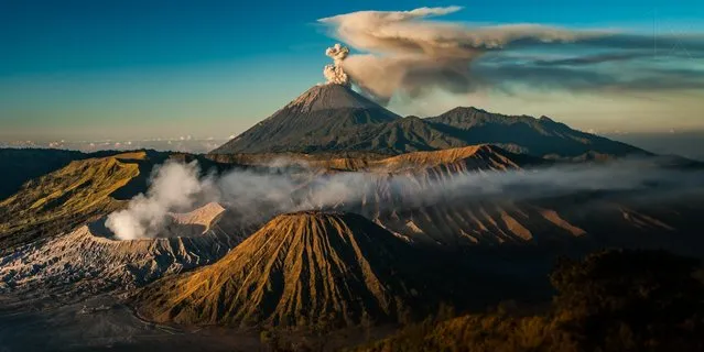 Smoke and ash rise from active volcaneos Mount Bromo and Mount Semeru in Indonesia in this spectacularly detailed shot. It won third place in the landscape category. (Photo by Adrian Rohnfelder/Head On)