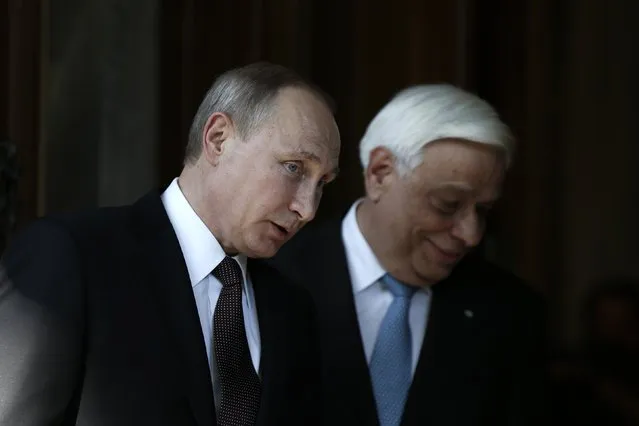Greek President Prokopis Pavlopoulos, right, welcomes Russian President Vladimir Putin at the Presidential Palace in Athens, Friday, May 27, 2016. (Photo by Alkis Konstantinidis/Reuters via AP Photo)