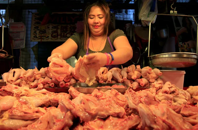 A vendor displays chicken for sale at her stall inside a wet market in metro Manila, Philippines May 19, 2016. (Photo by Romeo Ranoco/Reuters)