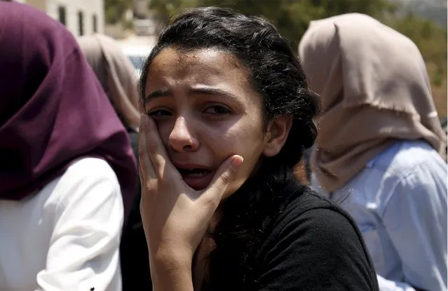 A relative of Palestinian youth Laith al-Khaldi mourns during his funeral near the West Bank city of Ramallah August 1, 2015. (Photo by Mohamad Torokman/Reuters)