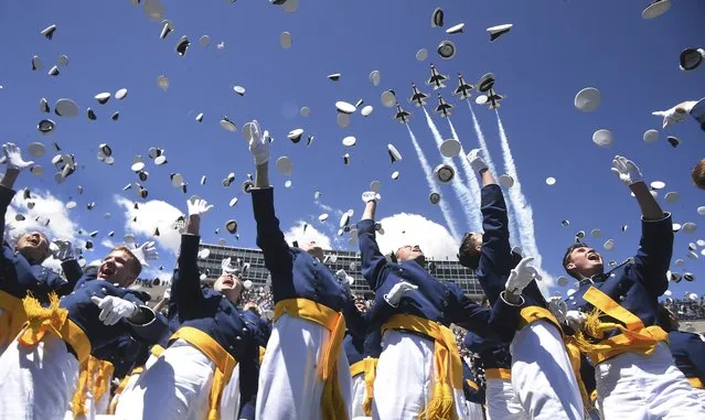 Air Force Academy cadets throw their hats into the air as the Thunderbirds flyover at the end of graduation on Wednesday, May 25, 2022 in Colorado Springs, Colo. (Photo by Jerilee Bennett/The Gazette via AP Photo)