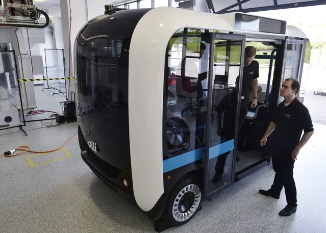 “Olli” an autonomous shuttle is seen at the Local Motors facility at the National Harbor in Maryland on June 16, 2016. The electric self-driving shuttle is partnership between Local Motors and IBM, using IBM's Watson supercomputer. “Olli”, which looks like a blocky miniature bus, can transport up to 12 passengers. Watson will be the technology that enables passengers to communicate with Olli while traveling. (Photo by Mandel Ngan/AFP Photo)