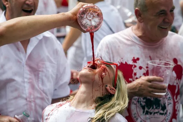 Samantha Kane Gale, an American who lives in Paris and has been attending the Fiesta de San Fermin ten times, has sangria poured on her as the Festival of San Fermin 2017 begins in Pamplona, Spain, 06 July 2017. The festival, locally known as Sanfermines, is held annually from 06 to 14 July in commemoration of the city's patron saint. Hundreds of thousands of visitors from all over the world attend the fiesta. Many of them physically participate in the highlight event – the running of the bulls, or encierro – where they attempt to outrun the bulls along a route through the narrow streets of the old city. (Photo by Jim Hollander/EPA)
