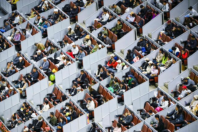 Spectators watch the men's singles final match between Italy's Jannik Sinner and Spain's Carlos Alcaraz at the China Open tennis tournament in Beijing on October 2, 2024. (Photo by Wang Zhao/AFP Photo)