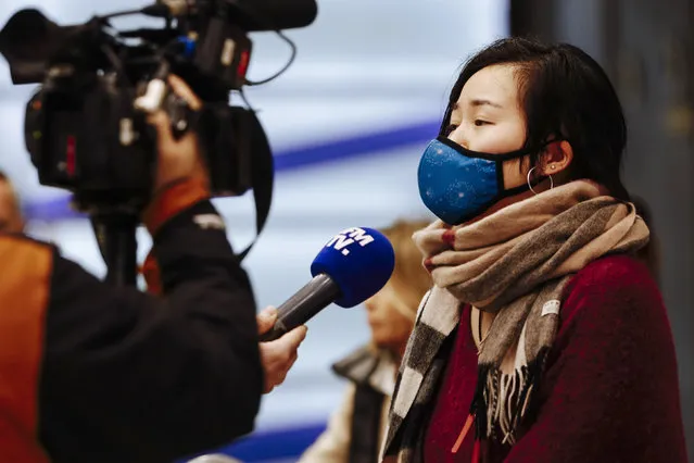 A traveler from Beijing speaks to a french TV named BFM TV as she arrives at Charles de Gaulle airport, north of Paris, early Monday, January 27, 2020. France's government announced Sunday it will repatriate up to hundreds of French citizens from the Chinese city of Wuhan, the epicenter of a deadly new virus. (Photo by Kamil Zihnioglu/AP Photo)