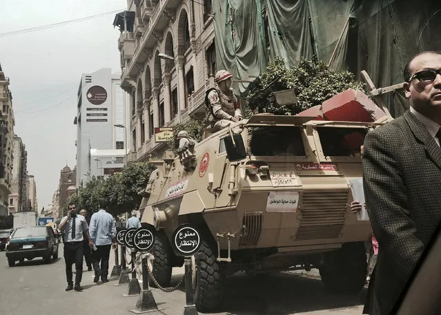 In this Monday, April 10, 2017 file photo, soldiers guard a street near a church in downtown Cairo, Egypt. The Palm Sunday deadly bombings of two churches left Egyptian President Abdel-Fattah el-Sissi grappling with the question of how to defeat a tenacious insurgency by Islamic State group militants. His predicament comes at a time when he’s also tackling the problem of repairing a broken economy, carrying out tough reforms that have won praise from economists but have dealt a devastating blow to most Egyptians. (Photo by Nariman El-Mofty/AP Photo)