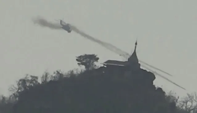In this image taken from video provided by Free Burma Rangers, a Myanmar military helicopter fires rockets west of Loikaw in Kayah State, Myanmar on February 21, 2022. While Russia’s war in Ukraine dominates global attention, Myanmar’s military is targeting civilians in air and ground attacks on a scale unmatched in the country since World War II, according to a longtime relief worker who spent almost three months in a combat zone in the Southeast Asian nation. (Photo by Free Burma Rangers via AP Photo)