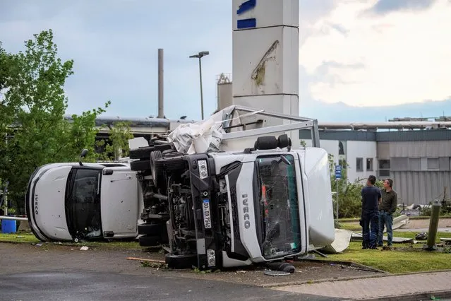 Two trucks overturned after a storm in Paderborn, Germany, Friday, May 20, 2022. A tornado swept through the western German city of Paderborn on Friday, injuring at least 30 people as it blew away roofs, toppled trees and sent debris flying for miles, authorities said. (Photo by Lino Mirgeler/dpa via AP Photo)