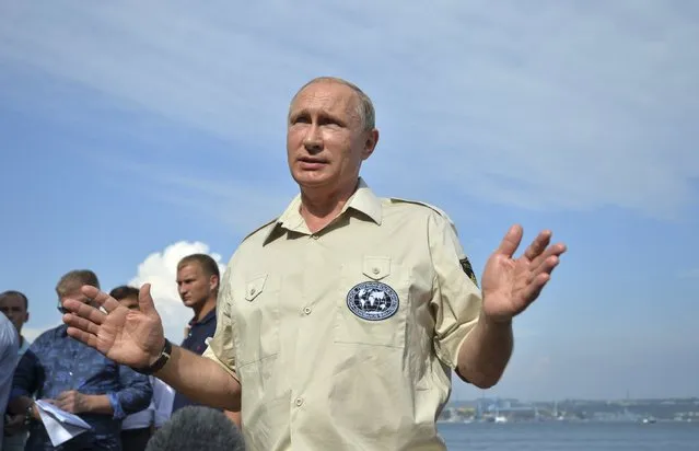 Russian President Vladimir Putin meets with journalists after submerging into the waters of the Black Sea inside a research bathyscaphe as part of an expedition in Sevastopol, Crimea, August 18, 2015. (Photo by Alexei Druzhinin/Reuters/RIA Novosti/Kremlin)