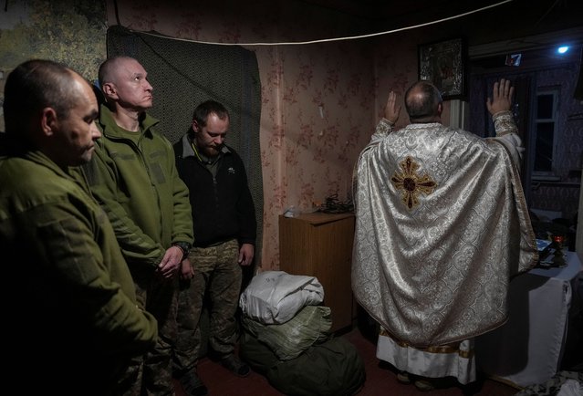 A military chaplain Yuriy conducts an Orthodox service for new recruits of the 24th Separate Mechanized Brigade of the Ukrainian Armed Forces, named after King Danylo, before their first combat mission, amid Russia's attack on Ukraine, near the town of Chasiv Yar in Donetsk region, Ukraine on November 3, 2024. (Photo by Inna Varenytsia/Reuters)