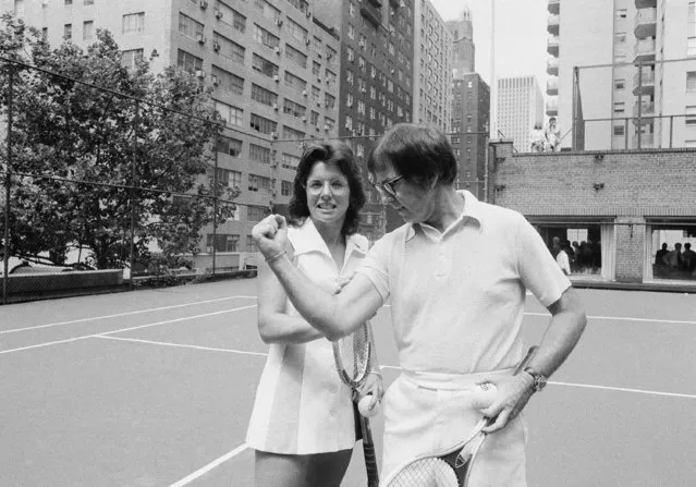 Wimbledon champion Billie Jean King checks the muscle on her nemesis, Bobby Riggs, in New York, July 11, 1973. King and Riggs announced they will meet in a $100,000 tennis grudge match like the one in which Riggs bested Margaret Court earlier this year. Time and place is yet to be announced.  Mrs. King is 26 years younger than Riggs. (Photo by Anthony Camerano/AP Photo)