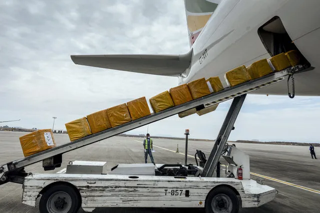 A cargo flight containing over 6 million medical items including face masks, test kits, face shields and protective suits arrives in the capital Addis Ababa, Ethiopia Sunday, March 22, 2020. The supplies arriving from Guangzhou, China for fighting the spread in Africa of the COVID-19 coronavirus were donated by the Jack Ma Foundation and Alibaba Foundation and will be distributed from Ethiopia to countries throughout Africa. (Photo by Mulugeta Ayene/AP Photo)