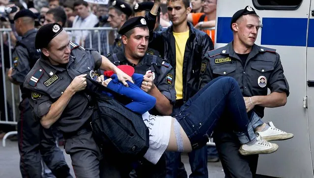 Police officers detain a supporter p*ssy Riot outside the court  in Moscow. (Photo by Alexander Zemlianichenko/Associated Press)