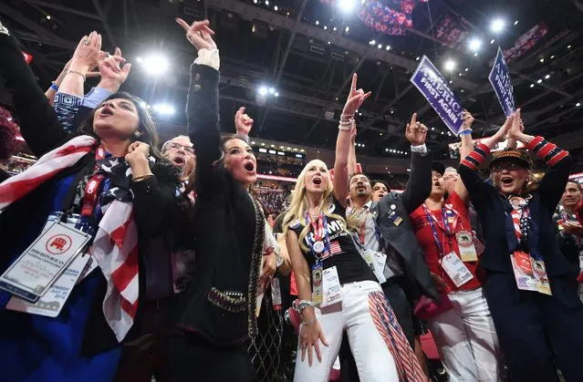 Delegates cheer on the floor of the Republican National Convention at Quicken Loans Arena in Cleveland, Ohio on July 20, 2016. The cost of the convention for the Republican Party will run some $64 million. The number of visitors expected in Cleveland is 50,000, including 15,000 journalists and 2,472 delegates (there are also 2,302 alternate delegates. (Photo by Jim Watson/AFP Photo)
