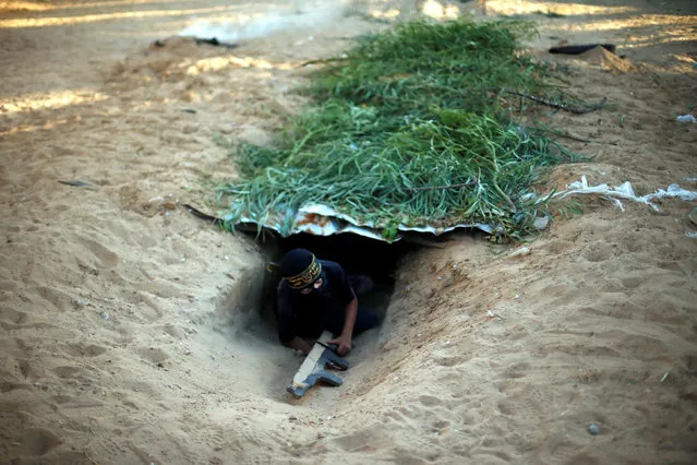 A young Palestinian crawls in a tunnel as he takes part in a military-style graduation ceremony at a summer camp organized by the Islamic Jihad Movement in Khan Younis in the southern Gaza Strip July 15, 2016. (Photo by Suhaib Salem/Reuters)