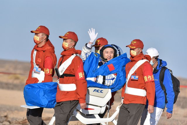 Space flight engineer Zhu Yangzhu waves as he leaves the capsule of the Shenzhou-16 spaceship after landing in China's Inner Mongolia on October 31, 2023. Three Chinese astronauts safely returned to Earth on October 31 after five months in orbit at the country's space station, state media reported. (Photo by AFP Photo/China Stringer Network)