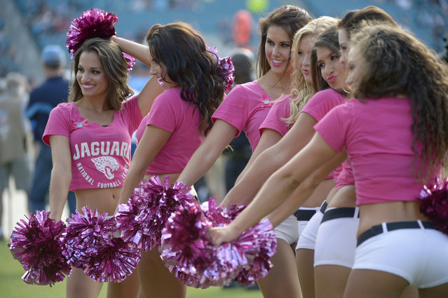 The Jacksonville Jaguars cheerleaders perform on the sideline during the second half of an NFL football game against the San Diego Chargers in Jacksonville, Fla., Sunday, October 20, 2013. (Photo by Phelan M. Ebenhack/AP Photo)