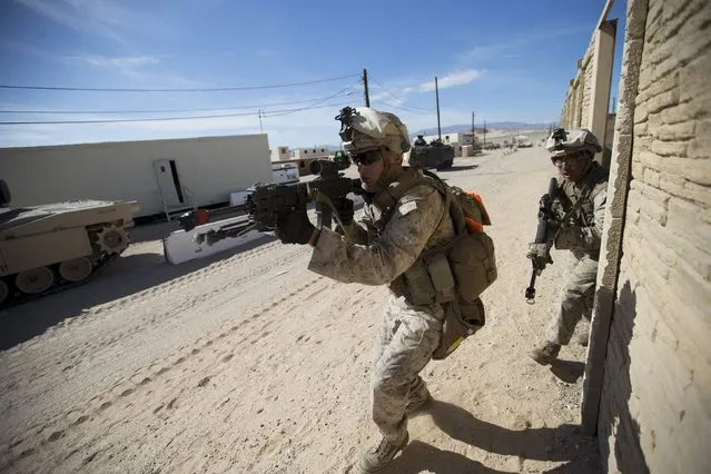 U.S. Marines from Fox Company, 2nd Battalion 1st Marines, 13th Marine Expeditionary Unit move ahead to clear a structure during a non-live fire Military Operations in Urban Terrain (MOUT) training at US Marine Corps: Marines Air Ground Combat Center in Twentynine Palms, California September 1, 2015. (Photo by Mario Anzuoni/Reuters)