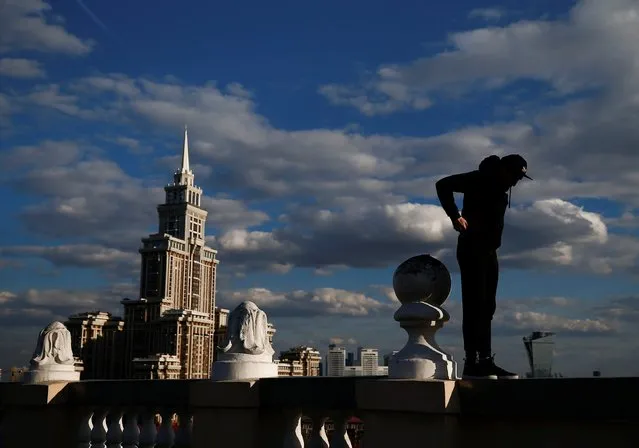 Grigory Shukhov of Rudex team stands on a parapet of a rooftop in Moscow, Russia, May 13, 2017. (Photo by Maxim Shemetov/Reuters)