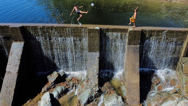 A drone view of children playing on a dam built by a mining company at the San Sebastian gold mine area in Santa Rosa de Lima, El Salvador on December 17, 2024. (Photo by Jose Cabeza/Reuters)