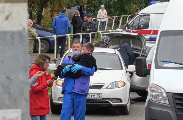In this image taken from video, an emergency situation employee caries a wounded boy from the scene of a shooting at school No. 88 in Izhevsk, Russia, Monday, September 26, 2022. (Photo by Izhlife.ru via AP Photo)