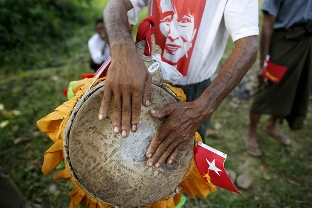A supporter wearing a Myanmar opposition leader Aung San Suu Kyi's picture t-shirt plays a traditional drum before she gives a speech during her campaign for the upcoming general election in Hpasaung, Kayah state, September 11, 2015. (Photo by Soe Zeya Tun/Reuters)