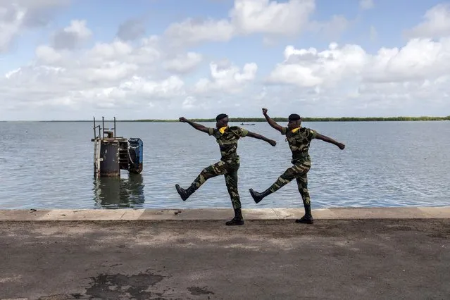 Two members of the Senegalese Armed Forces march during a ceremony for the anniversary of the capsizing of “Le Joola” in Ziguinchor on September 26, 2022. September 26th, 2022 marks the 20th anniversary of the capsizing of “Le Joola” ferry between Dakar and Ziguinchor, known as the largest civil maritime disaster, 1,863 dead and  missing according to the official report, more than 2,000 according to victim associations, of 12 different nationalities. Twenty years after Le Joola ferry sank, the Senegalese town where half of the nearly 1,900 dead lived will on Monday hold commemorations for a “wound that never heals”. (Photo by John Wessels/AFP Photo)