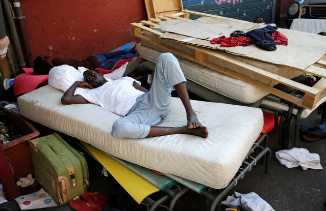 A migrant rests at a makeshift camp in Via Cupa (Gloomy Street) in downtown Rome, Italy, August 1, 2016. (Photo by Max Rossi/Reuters)