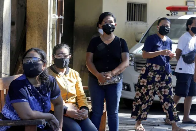 Women wait for a public testing for the new coronavirus conducted at a market in Bali, Indonesia on Friday, June 12, 2020. (Photo by Firdia Lisnawati/AP Photo)