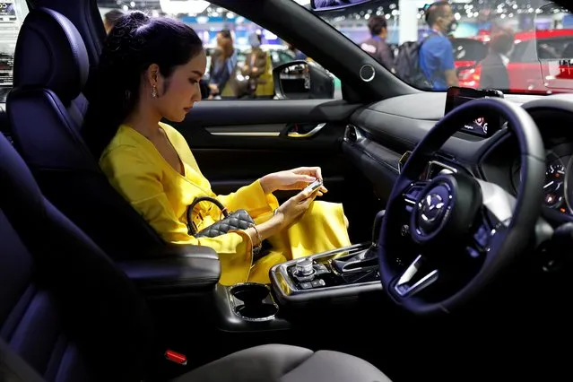 A customer sits in a Mazda CX-8 during the media day of the 41st Bangkok International Motor Show after the Thai government eased measures to prevent the spread of the coronavirus disease (COVID-19) in Bangkok, Thailand on July 14, 2020. (Photo by Jorge Silva/Reuters)