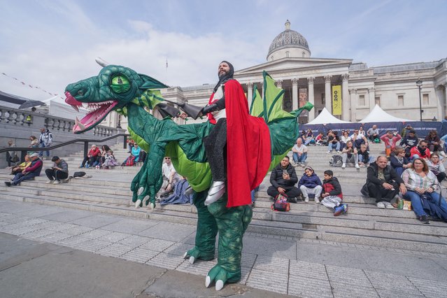 Saint George rides a dragon in Trafalgar Square in London on April 23, 2025. People enjoy the festivities on St George's Day in Trafalgar Square to celebrate English culture with appearances by St George and his Dragon, Pearly Kings and Queens, and carnival performers. (Photo by Amer Ghazzal/Alamy Live News)