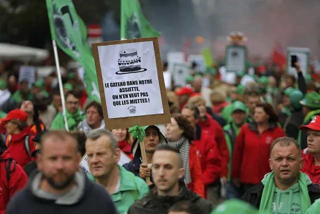 Demonstrators protesting government reforms and cost-cutting measures march in central Brussels, October 7, 2015.  The sign reads "We want more than just the crumbs of the cake!". (Photo by Francois Lenoir/Reuters)