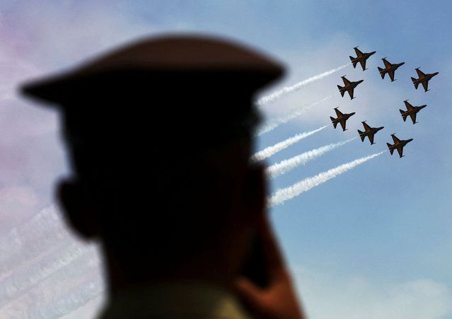 An Indonesian Air Force cadet watches the South Korea Air Force’s Black Eagles aerobatic team perform in their T-50Bs during an aerial display at the Singapore Airshow at Changi Exhibition Centre in Singapore on February 22, 2024. (Photo by Edgar Su/Reuters)