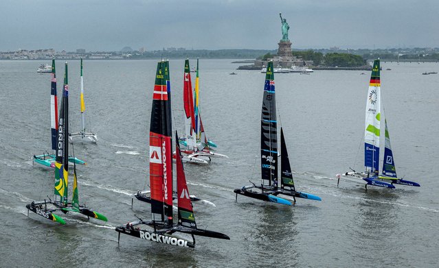 Germany SailGP F50 team driven by Erik Heil, New Zealand SailGP F50 team driven by Peter Burling and ROCKWOOL Denmark SailGP F50 team driven by Nicolai Sehested lead the SailGP fleet past the Statue of Liberty during the Mubadala New York Sail Grand Prix on June 7, 2025. (Photo by Samo Vidic/SailGP via Reuters)