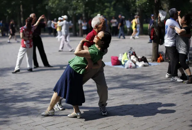 Locals dance during a morning exercise session at the Temple of Heaven park in Beijing. (Photo by Grace Liang/Reuters)