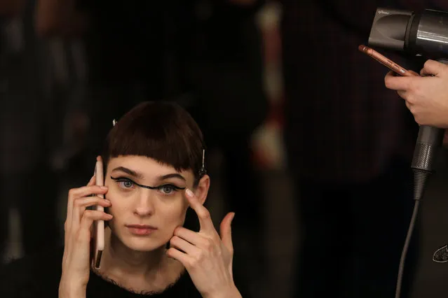 A model talks on the phone as she gets made up during the Mercedes-Benz Fashion Week in Madrid, Spain, January 25, 2018. (Photo by Susana Vera/Reuters)