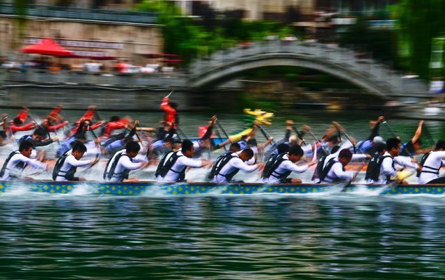 Dragon boat teams compete in a dragon boat race in Zhenyuan ancient town, Qiandongnan Miao and Dong Autonomous Prefecture, southwest China's Guizhou Province, July 22, 2025. (Photo by Xinhua News Agency/Rex Features/Shutterstock)